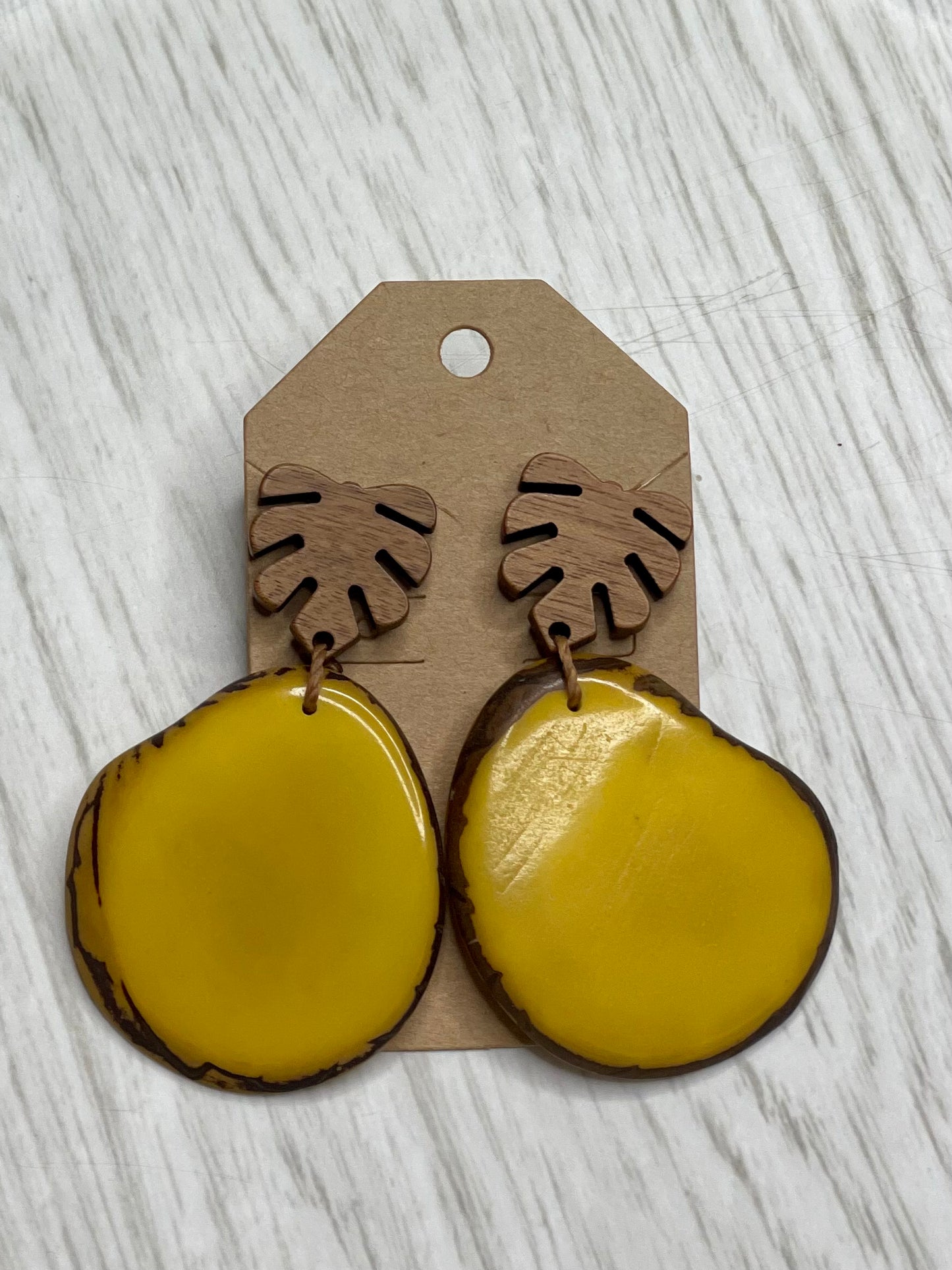 Tagua Earrings solid colorful tagua and wood monstera leaf design top with post earrings. tagua from Ecuador, made by artisans in Ecuador. Ecuador tagua jewelry. tropical earrings Tera yellow