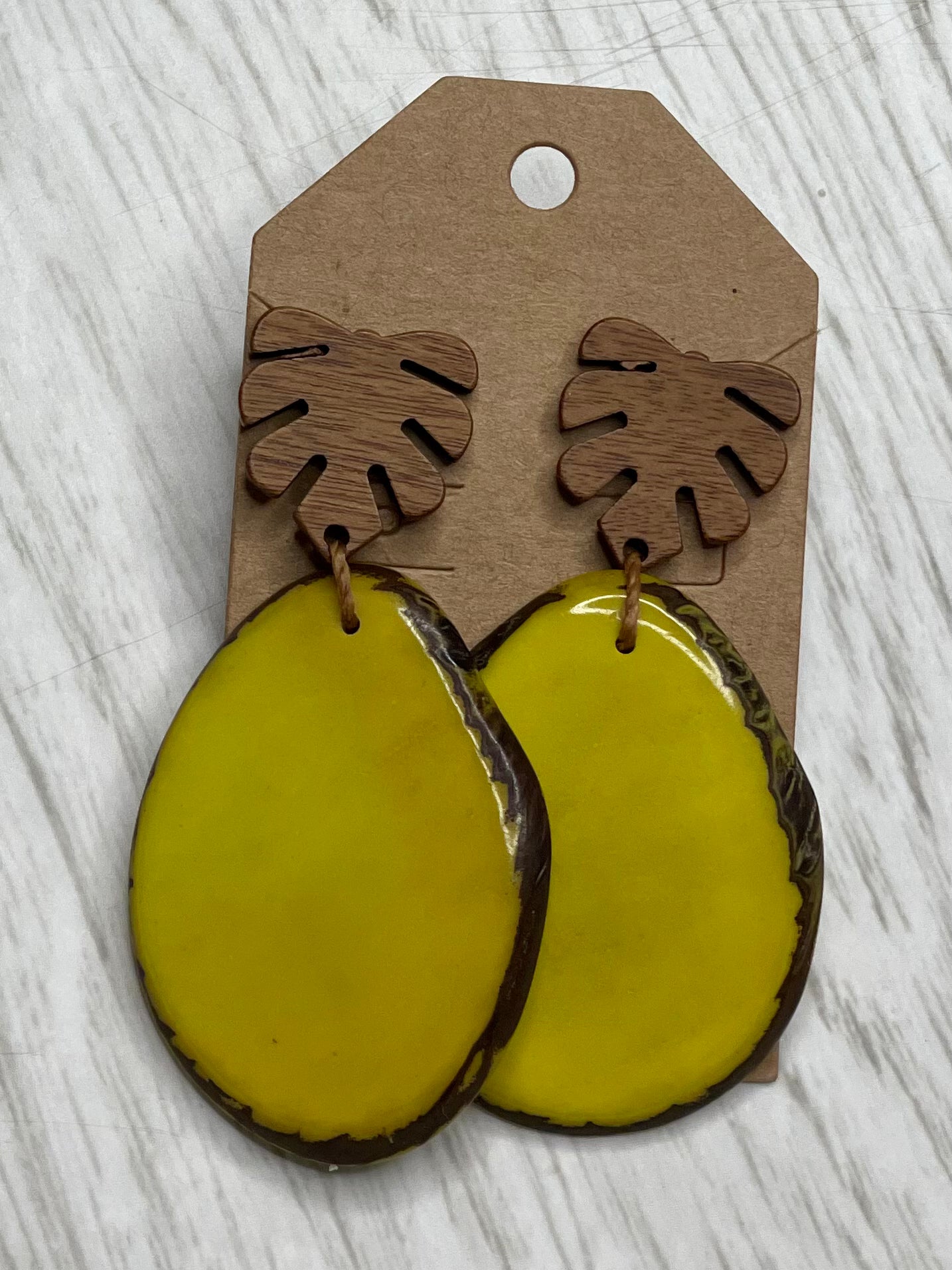 Tagua Earrings solid colorful tagua and wood monstera leaf design top with post earrings. tagua from Ecuador, made by artisans in Ecuador. Ecuador tagua jewelry. tropical earrings Tera limon yellow