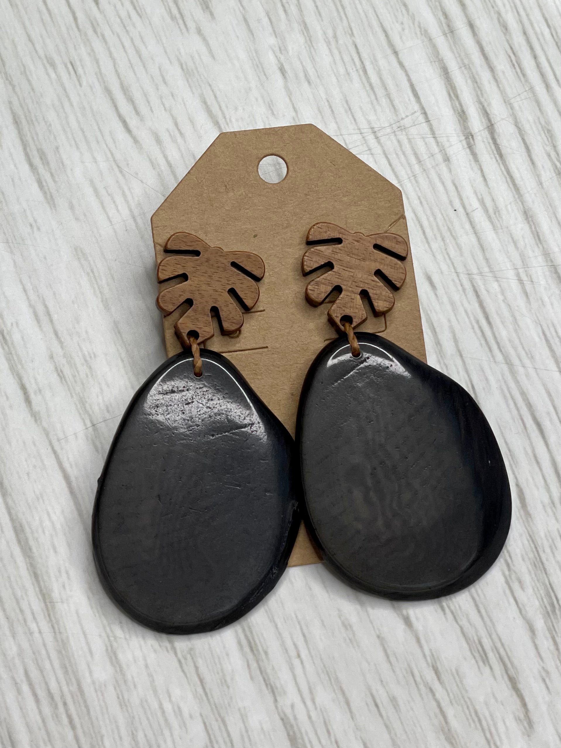 Tagua Earrings solid colorful tagua and wood monstera leaf design top with post earrings. tagua from Ecuador, made by artisans in Ecuador. Ecuador tagua jewelry. tropical earrings Tera carbon gray