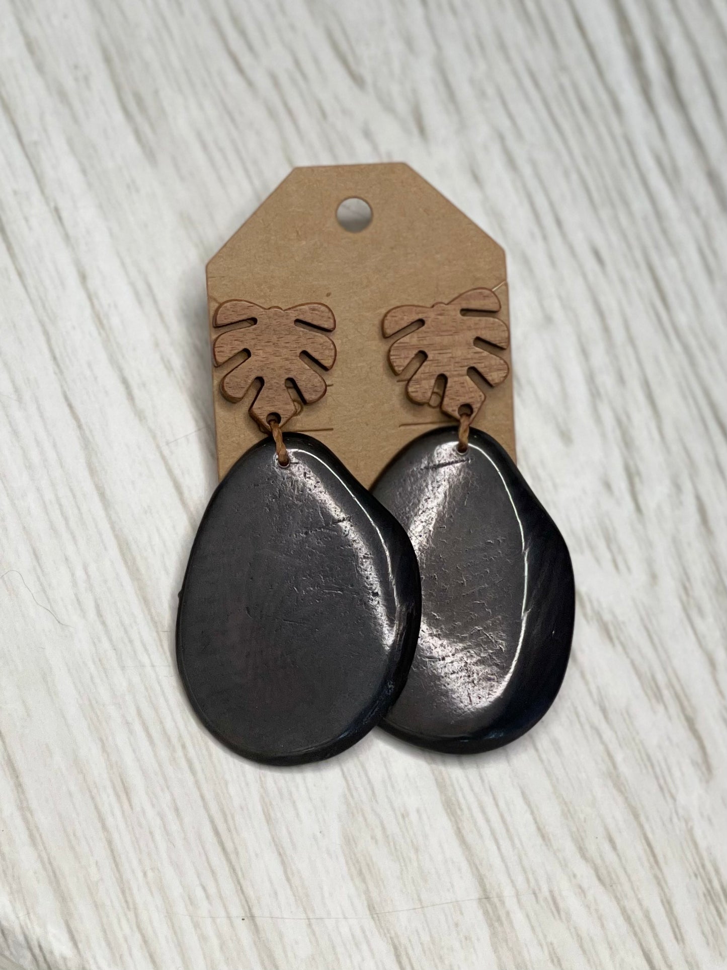 Tagua Earrings solid colorful tagua and wood monstera leaf design top with post earrings. tagua from Ecuador, made by artisans in Ecuador. Ecuador tagua jewelry. tropical earrings Tera carbon gray