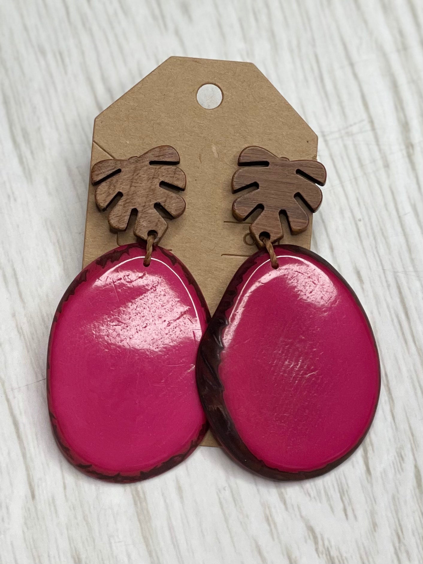 Tagua Earrings solid colorful tagua and wood monstera leaf design top with post earrings. tagua from Ecuador, made by artisans in Ecuador. Ecuador tagua jewelry. tropical earrings Tera fuschia pink